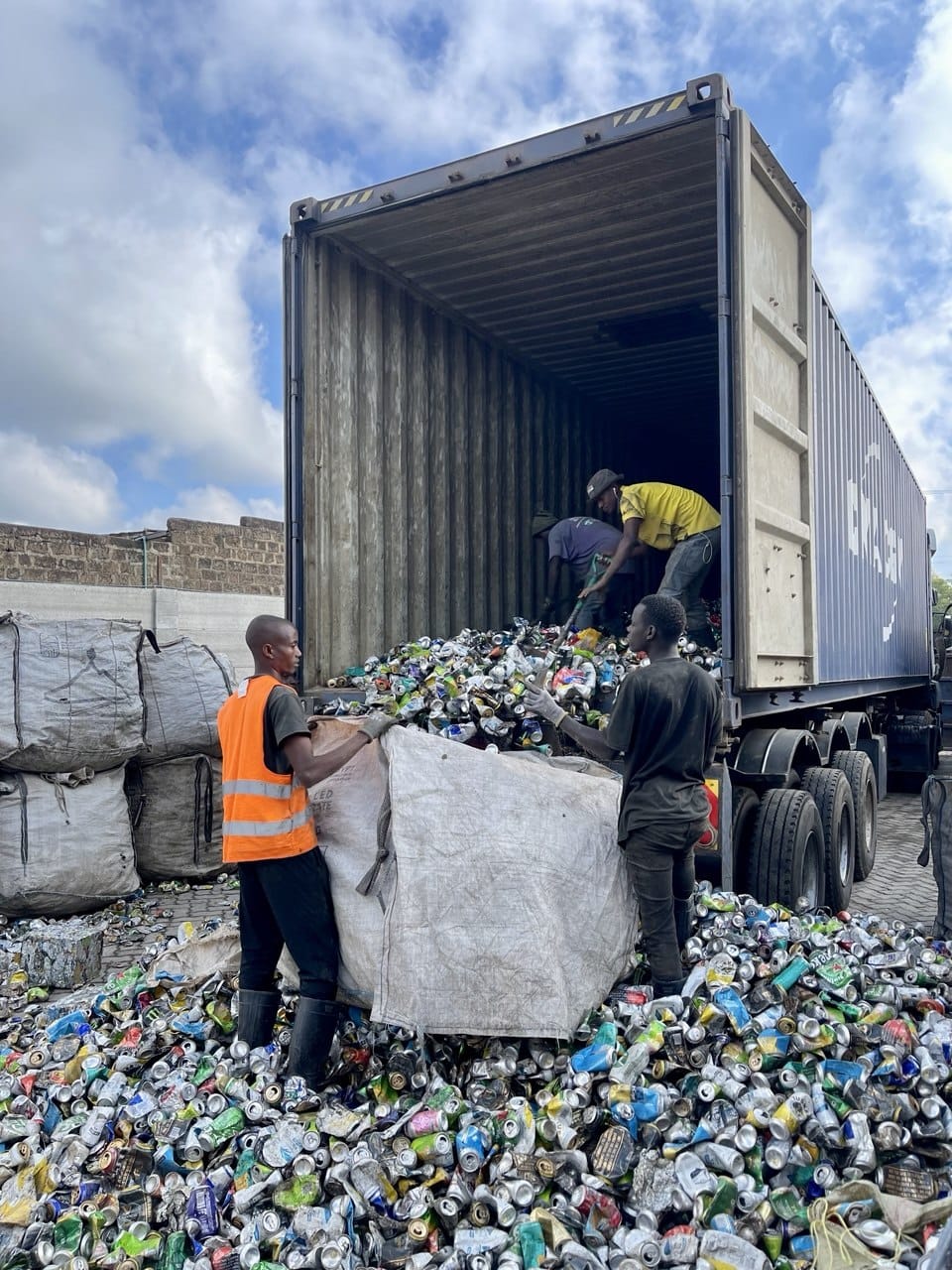 NUEF team loading baled aluminium cans into an export container at the Nairobi yard